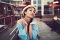 Portrait of beautiful smiling white Caucasian brunette girl on boat yacht pier quay, in blue dress and straw hat Royalty Free Stock Photo