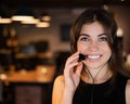 Portrait of a beautiful smiling woman call center operator with a headset at the desk Royalty Free Stock Photo