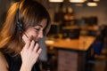 Portrait of a beautiful smiling woman call center operator with a headset at the desk Royalty Free Stock Photo