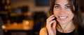 Portrait of a beautiful smiling woman call center operator with a headset at the desk Royalty Free Stock Photo