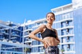 Portrait of beautiful smiling woman on the coast with blue sky against spa hotel. Royalty Free Stock Photo