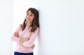 Portrait of beautiful smiling woman with crossed arms on white b Royalty Free Stock Photo