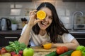 portrait of beautiful smiling woman at the kitchen with fruits and vegetables on the table Royalty Free Stock Photo