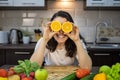 portrait of beautiful smiling woman at the kitchen with fruits and vegetables on the table Royalty Free Stock Photo