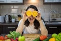 portrait of beautiful smiling woman at the kitchen with fruits and vegetables on the table Royalty Free Stock Photo
