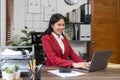 Portrait of beautiful smiling young businesswoman sitting at bright in office modern work and typing on laptop Royalty Free Stock Photo