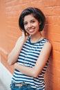 Portrait of beautiful smiling young Latin hispanic woman with short dark hair bob. Pretty hipster millennial in striped sleeveless