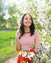 Portrait beautiful smiling young woman enjoying flowering garden Royalty Free Stock Photo