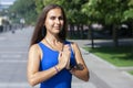 Portrait of beautiful smiling young woman enjoying yoga, relaxing, feeling alive, breathing fresh air