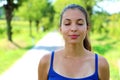 Portrait of beautiful smiling young woman enjoying yoga, relaxing, feeling alive, breathing fresh air, got freedom from work