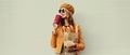 Portrait beautiful smiling young woman holding grocery shopping paper bag with long white bread baguette and cup of coffee on Royalty Free Stock Photo