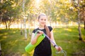 Portrait of a beautiful smiling young woman in a sports uniform with a jump rope and a yoga mat in her hands, posing Royalty Free Stock Photo