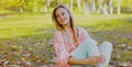 Portrait beautiful smiling young woman wearing a pink sweater in autumn park Royalty Free Stock Photo