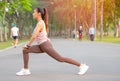 Portrait of beautiful sport girl action of leg stretched on the street in park or garden with morning light