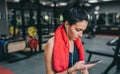 Portrait of a beautiful sporty young woman listening to music from her smartphone, preparing for a hard workout in the gym. People Royalty Free Stock Photo
