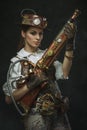 Portrait of a beautiful steampunk woman holding a gun Royalty Free Stock Photo