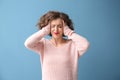 Portrait of beautiful stressed woman on color background