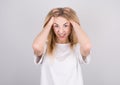 Portrait of beautiful stressed woman on gray background