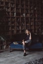 Portrait of a beautiful stylish blonde woman in a knitted headband, jacket and culottes in a loft interior. Soft selective focus, Royalty Free Stock Photo