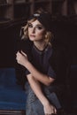 Portrait of a beautiful stylish blonde woman in a knitted headband in a loft interior. Soft selective focus, defocus. No Royalty Free Stock Photo