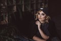 Portrait of a beautiful stylish blonde woman in a knitted headband in a loft interior. Soft selective focus, defocus. No Royalty Free Stock Photo