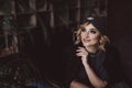 Portrait of a beautiful stylish blonde woman in a knitted headband in a loft interior. Soft selective focus, defocus. No Royalty Free Stock Photo