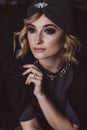 Portrait of a beautiful stylish blonde woman with smoky eye makeup in a knitted headband. Soft selective focus, defocus. No Royalty Free Stock Photo