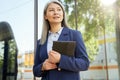 Portrait of a beautiful and succesful mature business woman wearing classic holding digital tablet, looking aside and Royalty Free Stock Photo