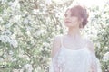 Portrait of a beautiful sweet gentle happy girl in a beige dress with a beautiful boudoir makeup hairstyle , photo processing in