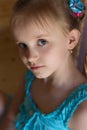 Portrait of a beautiful sweet little girl in a blue dress with blue eyes