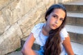 Portrait beautiful tanned caucasian girl against ancient stone wall. Attractive young tourist woman visiting city street Royalty Free Stock Photo