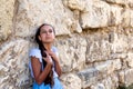 Portrait beautiful tanned caucasian girl against ancient stone wall. Attractive young tourist woman visiting city street Royalty Free Stock Photo