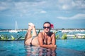 Portrait of beautiful tanned woman in black swimwear relaxing in swimming pool spa. Hot summer day and bright sunny Royalty Free Stock Photo