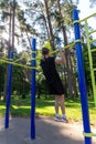 Portrait of beautiful teen age athletic girl training outdoors at open air gym at summer sunny day Royalty Free Stock Photo