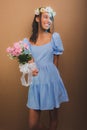 Portrait of beautiful teenage girl standing holding bouquet of flowers Royalty Free Stock Photo