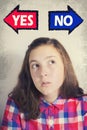 Portrait of beautiful teenage girl thinking what to choose between YES and NO Royalty Free Stock Photo