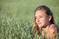 Portrait of a beautiful teenager girl in a oat meadow