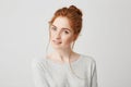 Portrait of beautiful tender redhead girl smiling posing looking at camera over white background. Royalty Free Stock Photo