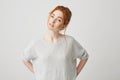 Portrait of beautiful tender redhead girl smiling posing looking at camera over white background. Royalty Free Stock Photo