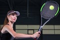 Portrait of a beautiful tennis player training on the court. Sports concept