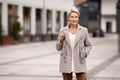 Portrait of beautiful trustable mature business woman with blonde short haircut fashionably dressed in double breasted Royalty Free Stock Photo