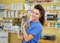 Portrait of a beautiful veterinarian holding cat at clinic.