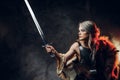 Portrait of a beautiful warrior woman holding a sword wearing steel cuirass and fur. Fantasy fashion. Cosplayer as Ciri Royalty Free Stock Photo