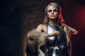 Portrait of a beautiful warrior woman holding a sword wearing steel cuirass and fur. Fantasy fashion. Cosplayer as Ciri