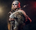 Portrait of a beautiful warrior woman holding a sword wearing steel cuirass and fur. Fantasy fashion. Cosplayer as Ciri