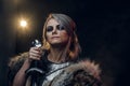 Portrait of a beautiful warrior woman holding a sword wearing steel cuirass and fur. Fantasy fashion. Cosplayer as Ciri Royalty Free Stock Photo