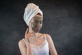 Portrait of beautiful Woman applying nourishing green clay mud mask to her face isolated on black Royalty Free Stock Photo