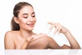 Portrait of beautiful woman applying some cream to her face for skin care. Cosmetology concept. Royalty Free Stock Photo