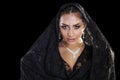 Portrait of a beautiful woman with arabian makeup in black paranja