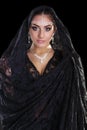 Portrait of a beautiful woman with arabian makeup in black paranja